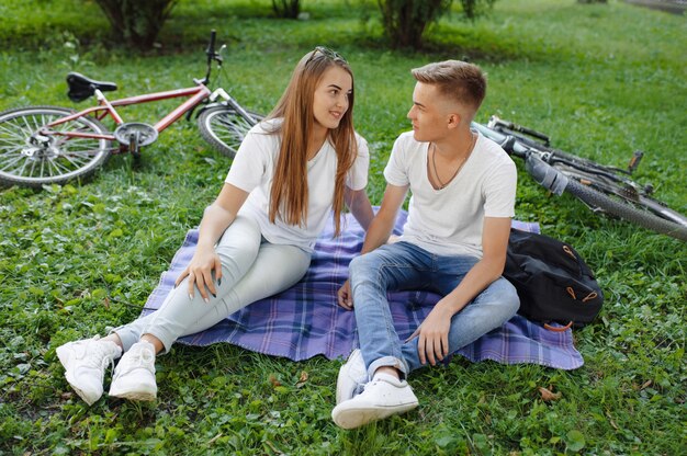 Couple sitting in a park with bicycle