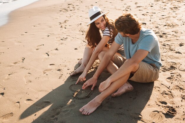 Couple sitting next to the sea talking