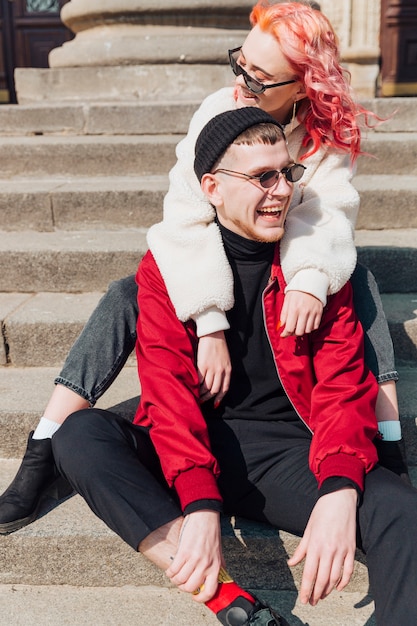 Couple sitting on stairs and having fun