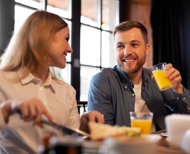 Couple sitting at table medium shot