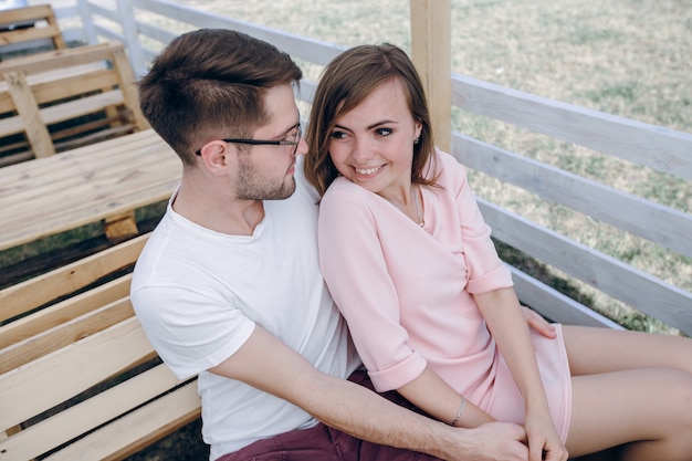 Couple sitting together on a wooden bench