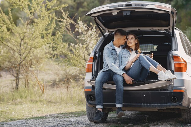 Couple sitting in a trunk in a park