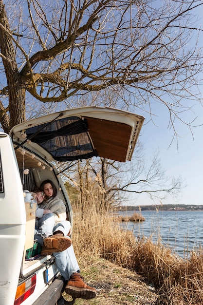 Couple sitting in van full shot