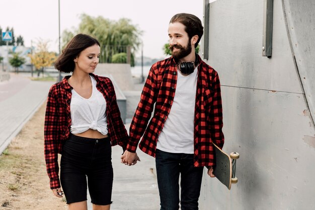 Couple in skate park holding hands