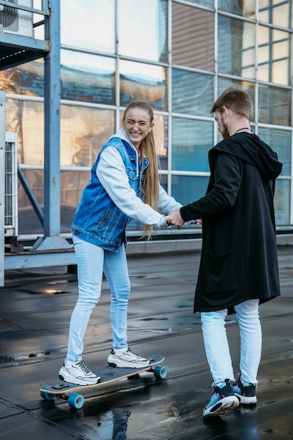 Couple skateboarding together outdoors