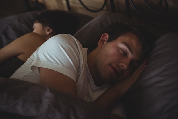 Couple sleeping on bed in the bedroom