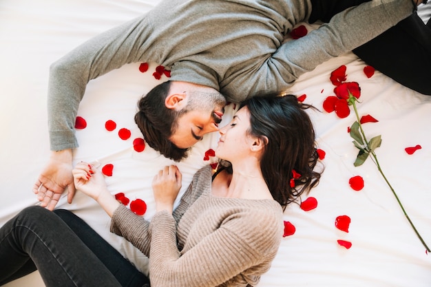 Couple sleeping on rose petals