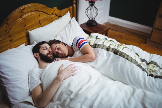 Couple sleeping together on bed