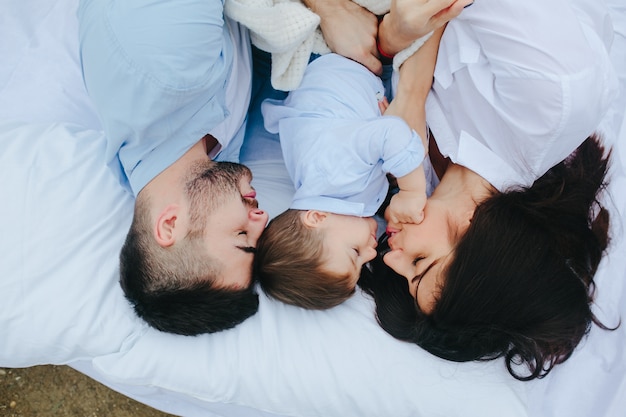 Couple sleeping with son