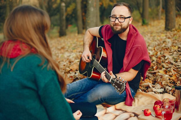 Couple spend time in a autumn park