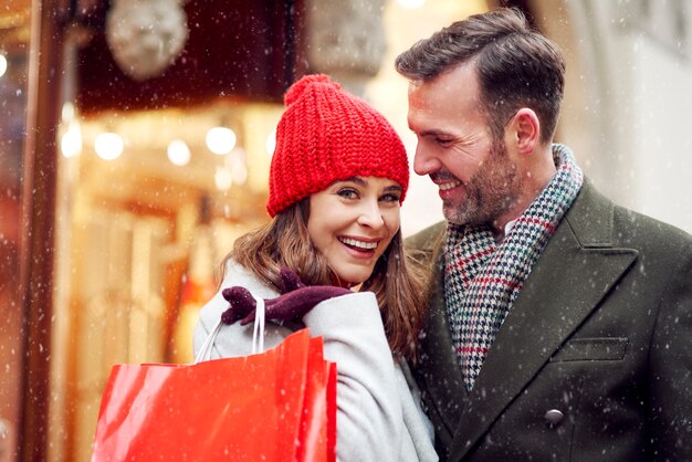 Couple spending some money during winter shopping