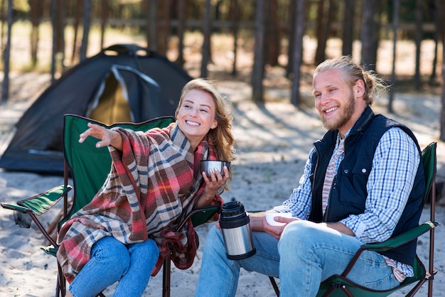 Couple spending time together next to their tent