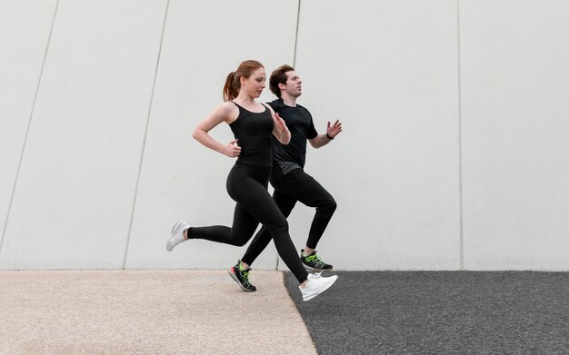 Couple in sportswear exercising outdoors