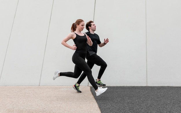 Couple in sportswear exercising outdoors