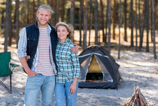 Free photo couple standing in front of tent