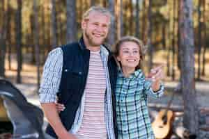 Free photo couple standing in front of tent