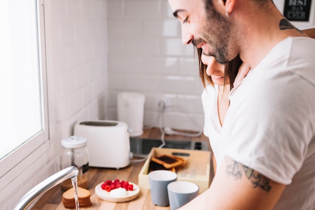 Couple standing in kitchen