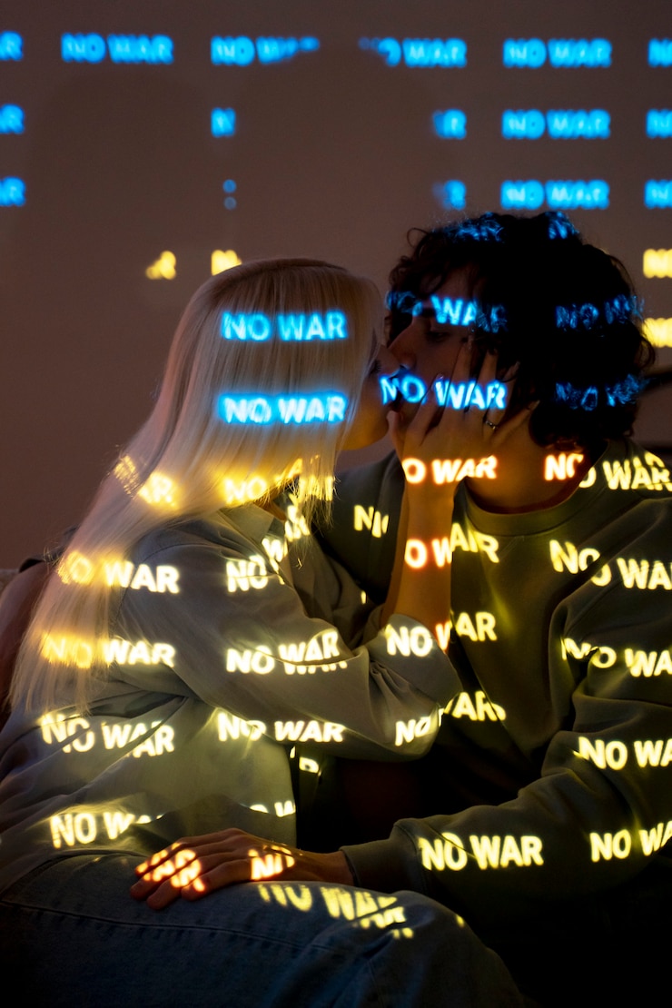 Free Photo couple staying in the light of no war wording
