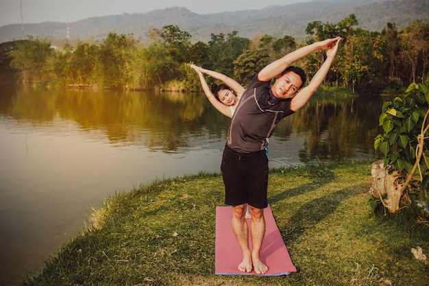 Couple stretching and relaxing in the nature