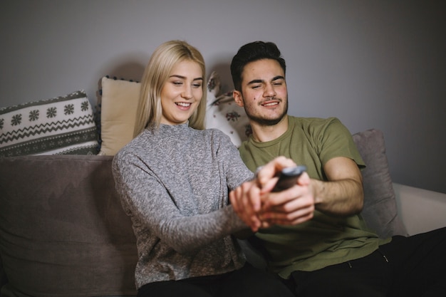 Couple struggling for remote control