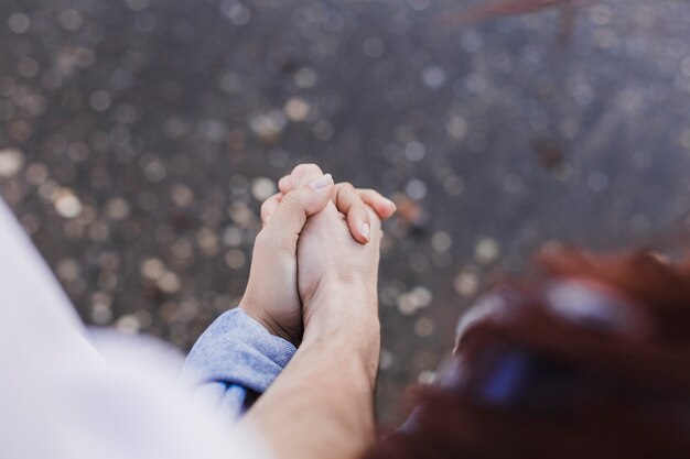 Couple and summer concept with close up of couple holding hands