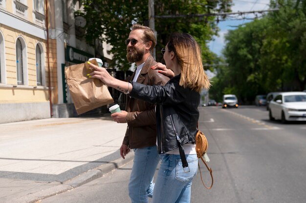 Couple in synthetic leather jackets walking in the city together