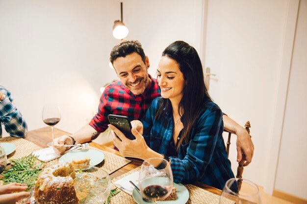 Couple at table with smartphone