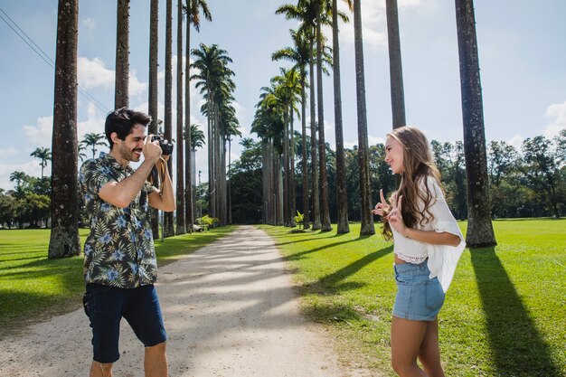 Couple taking photo on palm tree path