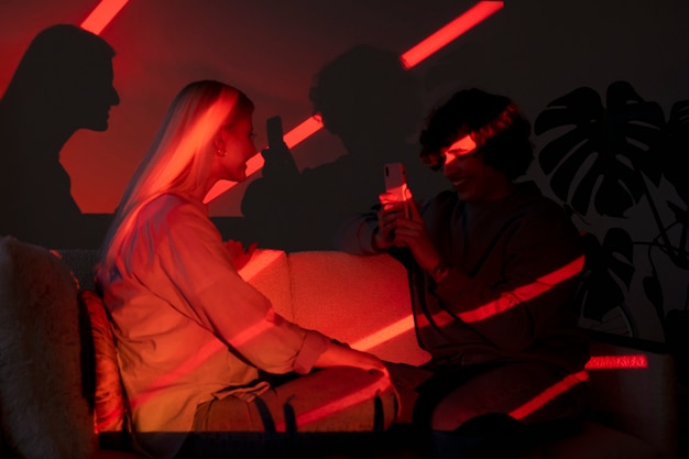 Couple taking photos in the light of movie projector