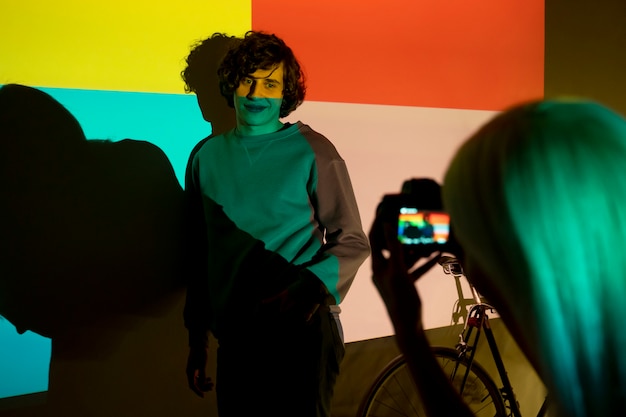 couple taking photos in the light of movie projector