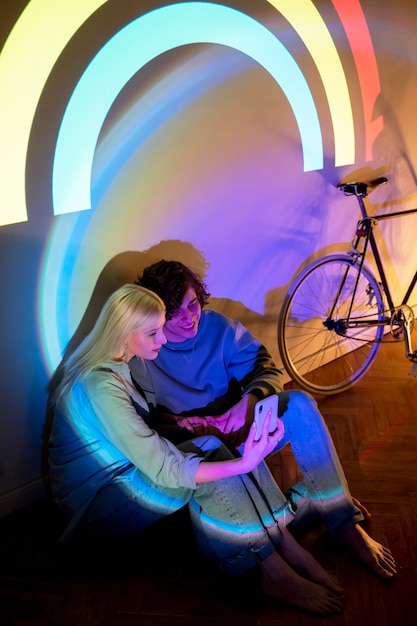 couple taking photos in the light of movie projector