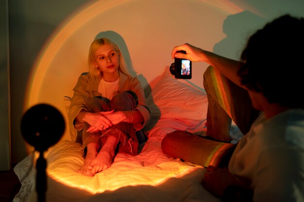 Couple taking photos in the light of movie projector