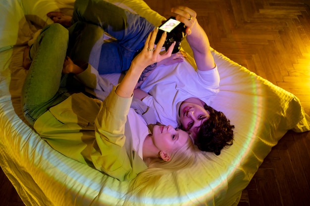 Couple taking photos in the light of movie projector