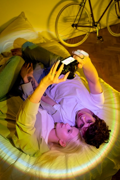 couple taking photos in the light of movie projector