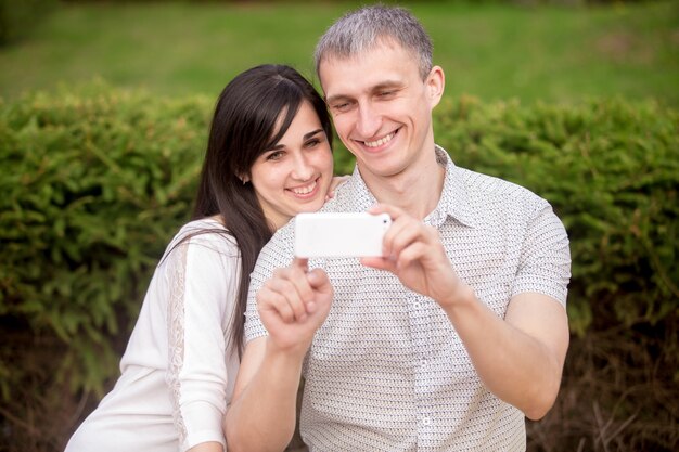 Couple taking self portrait with phone