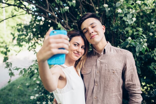 Couple taking selfie in park