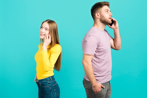 Couple talking by mobile phone