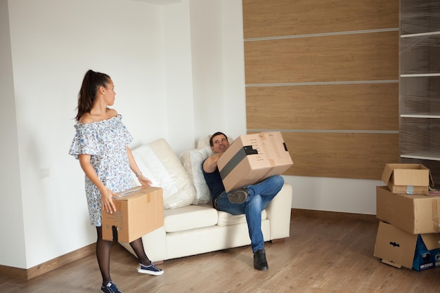 Couple talking to each other after unpacking the boxex in their new home