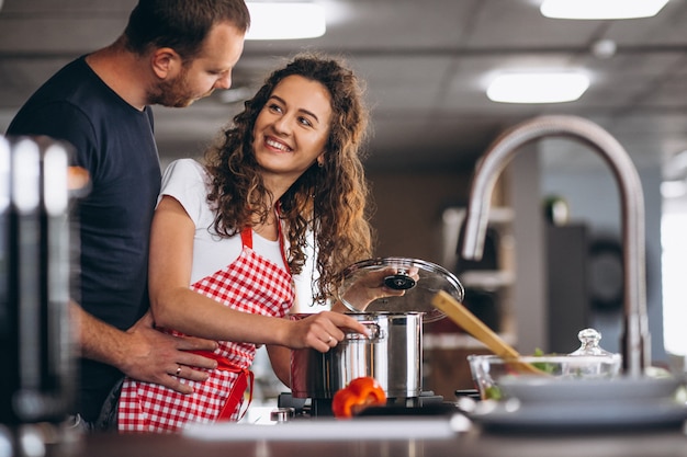 Couple together cooking at the kitchen