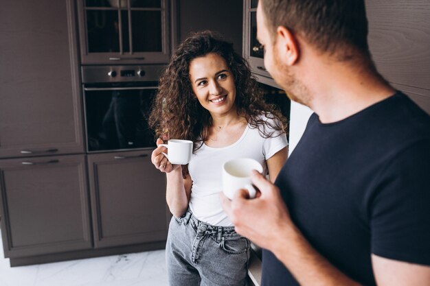 Couple together at the kitchen drinking coffee