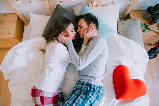 Couple touching faces tenderly during sleep