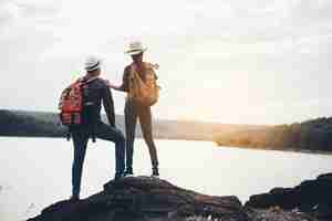 Free photo couple of tourists with backpacks on mountain