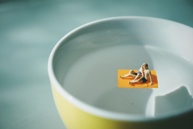 Couple in a towel over water from a cup of coffee