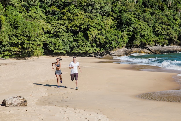 Free photo couple training on the beach