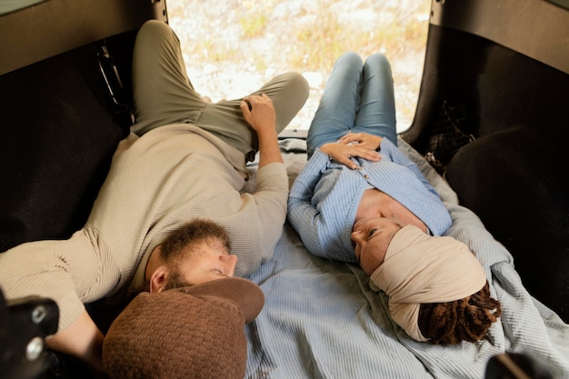 Couple traveling by car laid in the back
