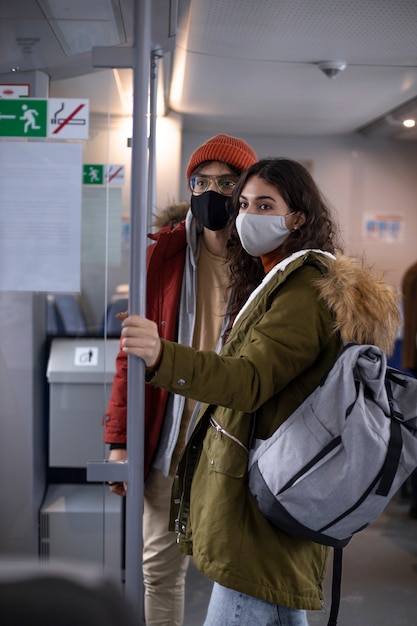 Couple traveling by train with backpacks