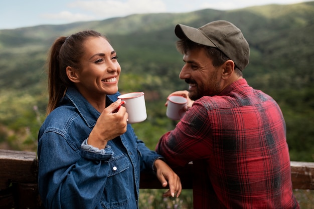 Couple traveling in nature and enjoying a beverage
