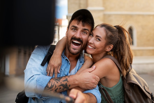couple traveling and taking selfie together in the city