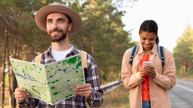 Couple traveling together with the help of a map