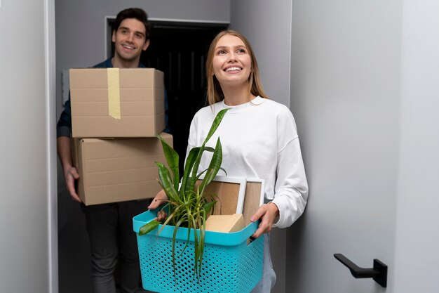 Couple unpacking boxes of belongings after moving in a new house